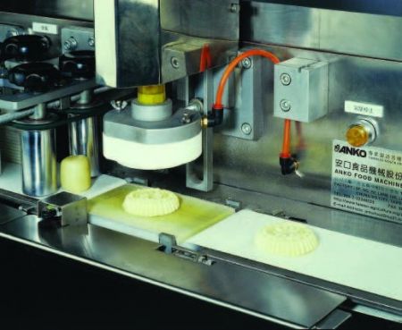 Automatic Mammoul And Moon Cake Production Line - Stamping mammouls to desired shape and design.