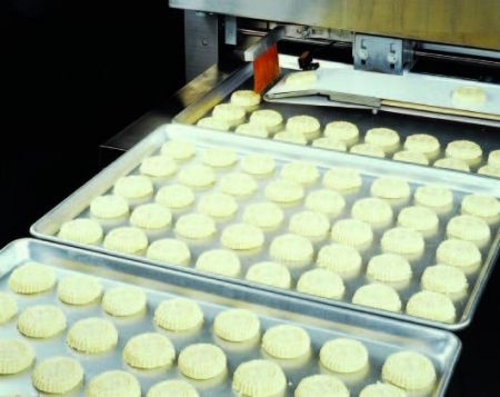 Automatic Mammoul And Moon Cake Production Line - Aligning mammouls on baking trays.